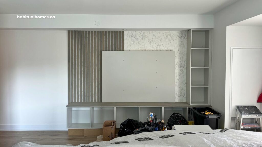 Custom media wall construction in progress in a Bloor East Toronto condo, framing and drywall before finishes are applied